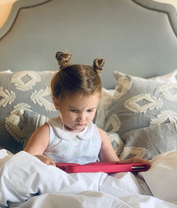 little girl ipad in bed