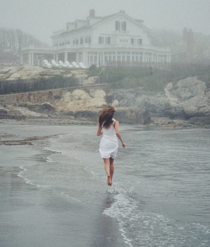 woman running in mist on beach